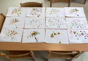Zdjęcie wykonanych przez dzieci z grupy Pszczółki parasolek za pomocą kropeczek z plasteliny.
