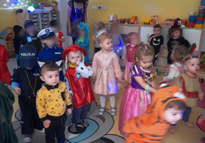 Dzieci tańczące w przebraniach na balu kostiumowym.