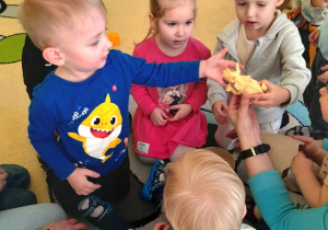 Dzieci oglądające wspólnie szkielet dinozaura.