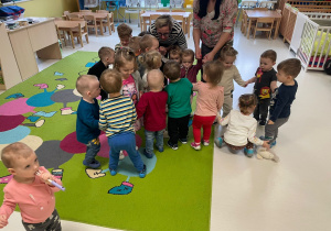 Dzieci z grupy Żabki podczas zabawy aktywnej na dywanie.